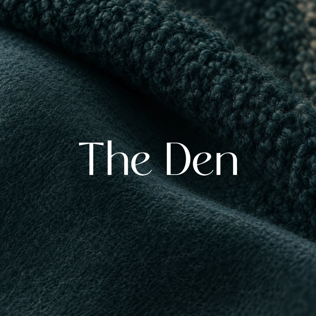 The Den logo in white on a dark abstract boucle-texture background.